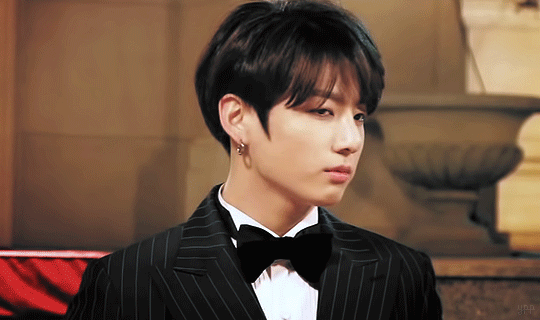 A photo of BTS's Jungkook as a mob boss, in a black suit, in the 