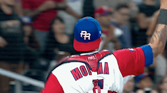 Yadier Molina and Javier Baez of team Puerto Rico walk into the